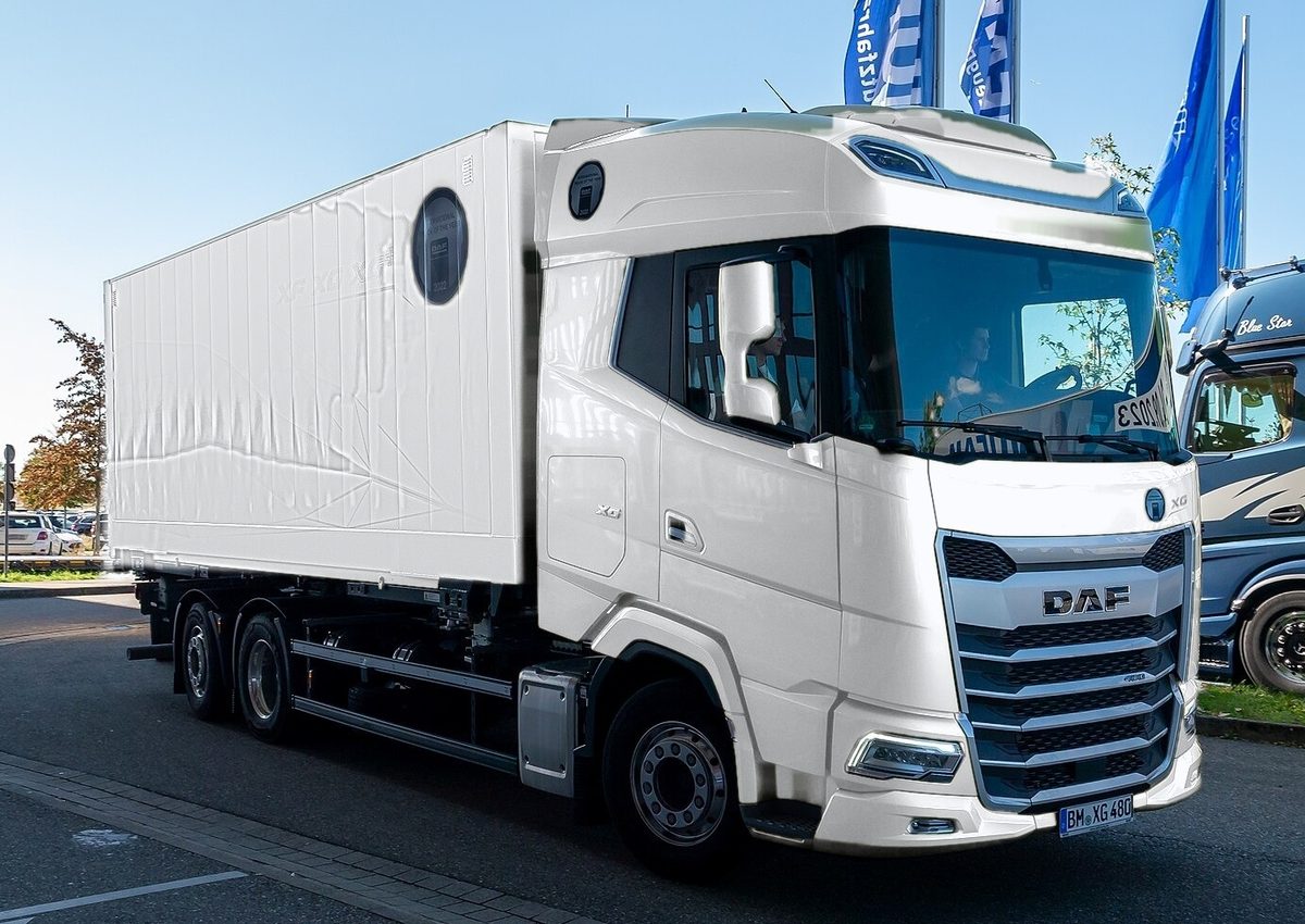 White DAF XG rigid truck with a box body and three axles